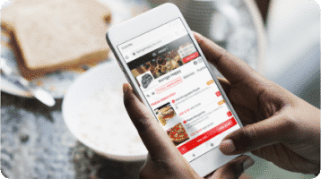 A person selecting products from a digital menu with his mobile device asking for a food delivery